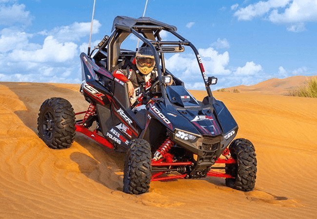 The Polaris RZR XP 1000 (1-Seater) is a high-performance dune buggy (UTV) built for aggressive off-roading. With its powerful 999cc engine, long-travel suspension, and race-ready design, it’s ideal for extreme desert adventures in Dubai. This vehicle offers full control, fast acceleration, and a thrilling ride over red sand dunes — perfect for solo riders who want an adrenaline-filled private experience.